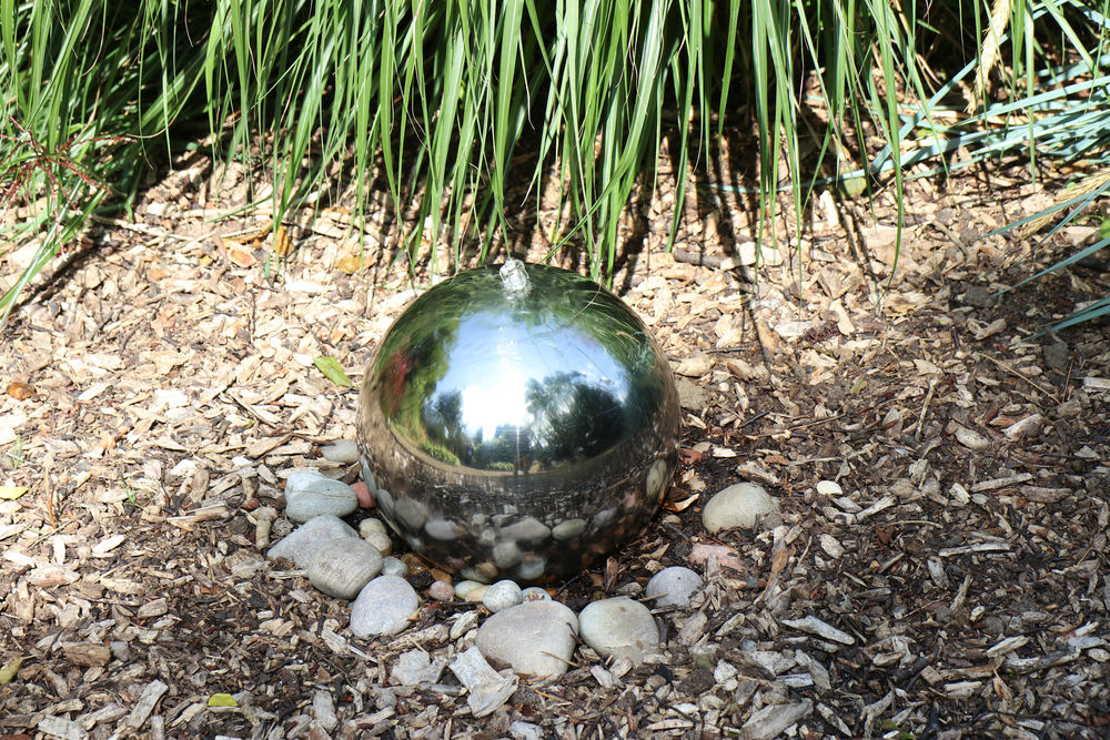 Ornamental metal fountain ball in Elgoods Brewery Gardens, Wisbech, Cambridgeshire.
 #waterfeature #fountainball #elgoodsfountain