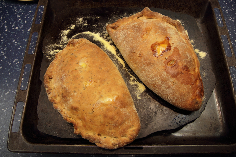 Folded breakfast calzone pizza on a pizza stone.jpg.