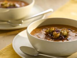 Red onion and roast cherry tomato soup with pesto croutons