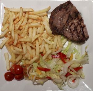 Sous-vide rib-eye steak with red pepper onions and sage