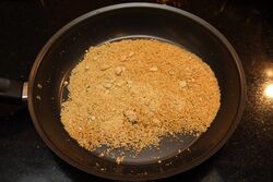 Toast the ground almonds in a thin-based pan