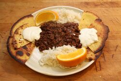 Chili con carne numero uno, homemade tortilla chips, plain rice, soured cream and orange slices