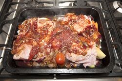 Tomato mixture poured over the pork