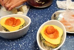 Line the halved squashes with pepperoni slices