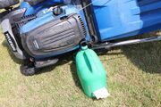 Drain the right amount of fuel so you can tip the mower over without losing petrol or flooding the motor