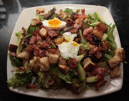 Crispy bacon salad with poached eggs and croutons