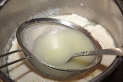 Press the sieve down and drain with a ladle