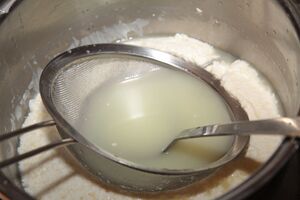 Press the sieve down and drain with a ladle