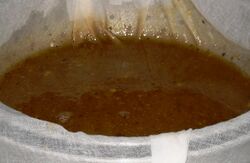 Straining the stock through cheesecloth