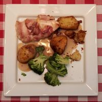 Sous vide bacon wrapped chicken filled with garlic and cheese