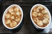 Dumplings, coated with gravy and ready to cook.