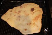 Stone baked base resting while the other base is cooking