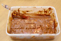 Meat-side up, covered in the rub