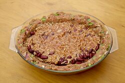 The pie dish (casserole dish) lined and filled